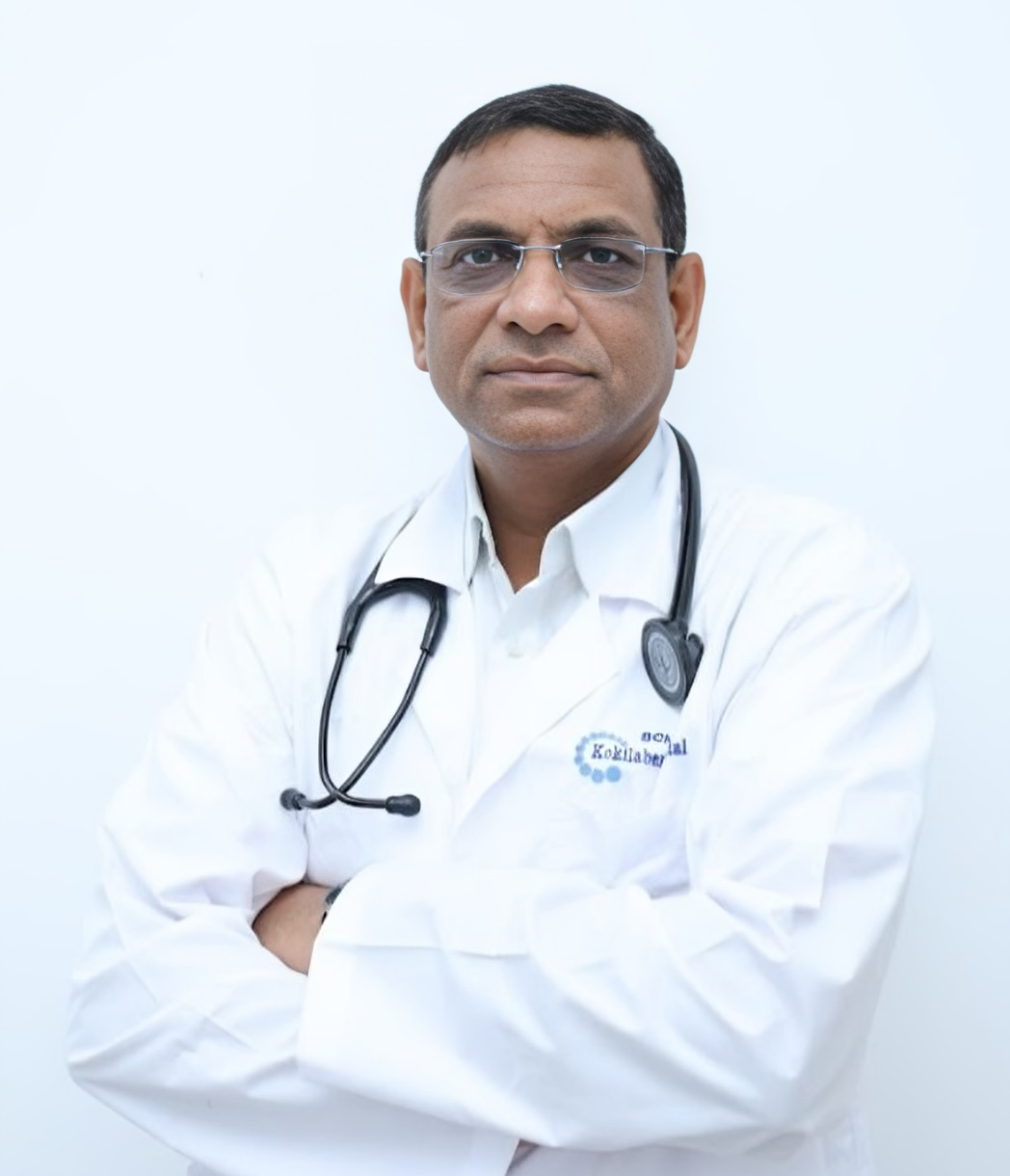 Photo of Dr. Akhilesh Jain, the Best Cardiologist in Indore, wearing a white coat with a stethoscope around his neck, standing with arms crossed.